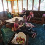 A group of House guests watch a movie at Movie Night